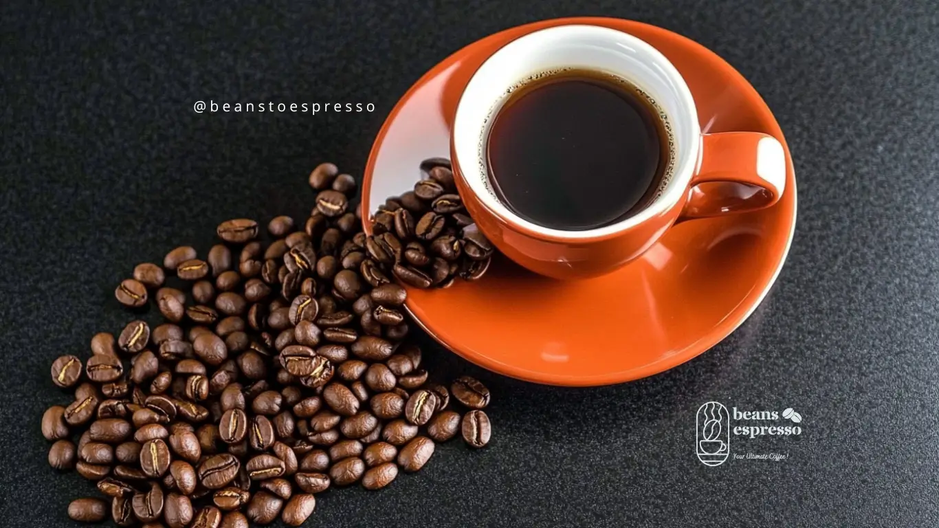 A freshly pulled espresso shot with coffee beans and a grinder in the background, showcasing the process from beans to espresso.